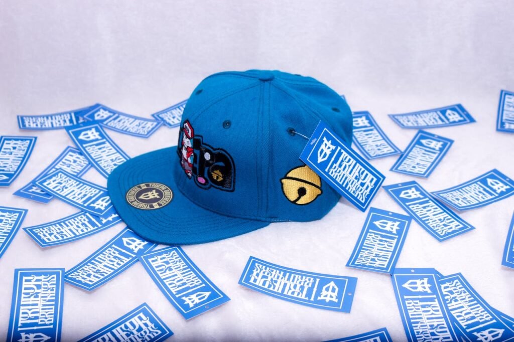 Mastering the First Impression: Your intriguing post title goes here A vibrant blue baseball cap surrounded by branded stickers in a studio setup.